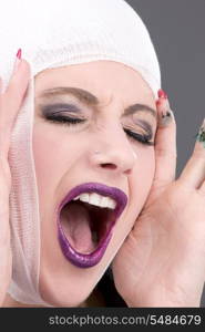 picture of screaming wounded woman face over grey