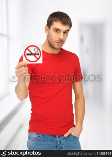 picture of serious man in red shirt with no smoking sign