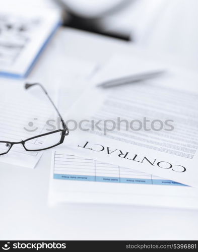 picture of signed contract paper with glasses