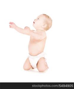 picture of sitting baby boy in diaper over white