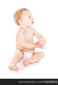 picture of sitting baby boy in diaper over white