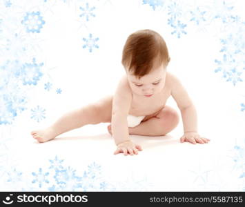 picture of sitting baby boy in diaper with snowflakes
