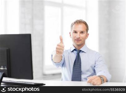 picture of smiling businessman showing thumbs up