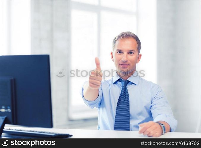 picture of smiling businessman showing thumbs up. smiling businessman showing thumbs up