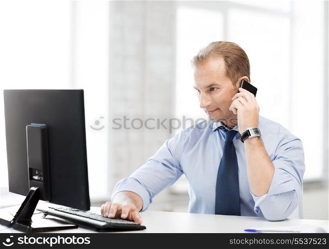 picture of smiling businessman with smartphone in office