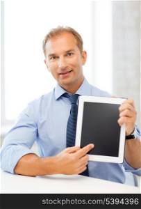 picture of smiling businessman with tablet pc in office