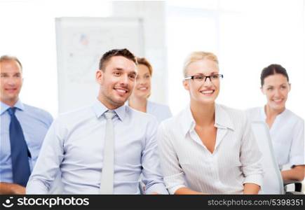 picture of smiling businessmen and businesswomen on conference