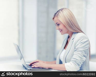 picture of smiling businesswoman using her laptop computer. businesswoman with laptop