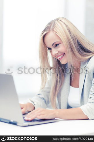 picture of smiling businesswoman using her laptop computer. businesswoman with laptop