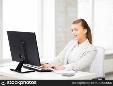 picture of smiling businesswoman with computer in office
