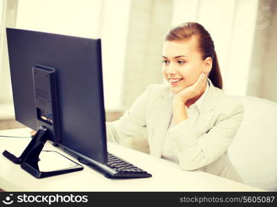 picture of smiling businesswoman with computer in office