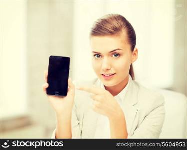 picture of smiling businesswoman with smartphone in office