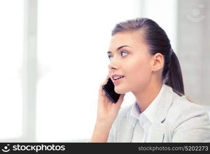 picture of smiling businesswoman with smartphone in office. businesswoman with smartphone in office