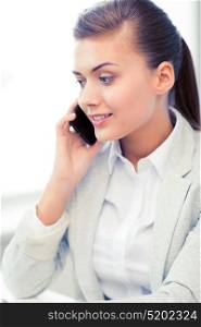 picture of smiling businesswoman with smartphone in office. businesswoman with smartphone in office