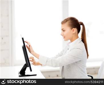 picture of smiling businesswoman with touchscreen in office