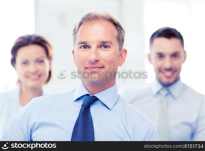 picture of smiling handsome businessman in office. businessman in office
