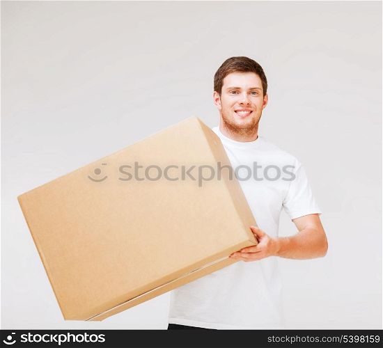 picture of smiling man carrying carton box