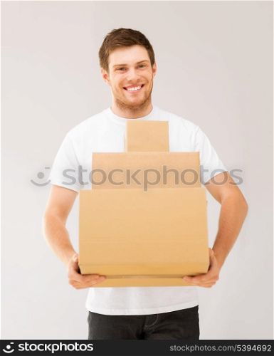 picture of smiling man carrying carton boxes