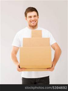 picture of smiling man carrying carton boxes