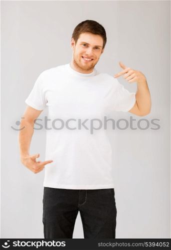 picture of smiling man pointing at blank white t-shirt