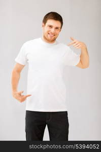 picture of smiling man pointing at blank white t-shirt