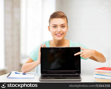 picture of smiling student girl with laptop at school