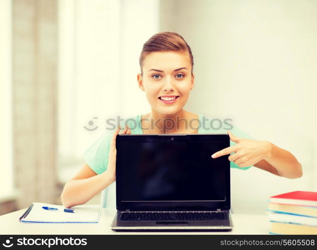 picture of smiling student girl with laptop at school