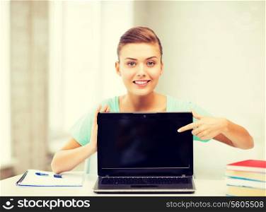 picture of smiling student girl with laptop at school