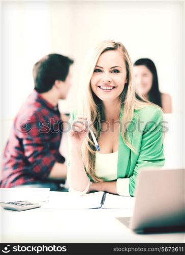 picture of smiling student girl with laptop at school