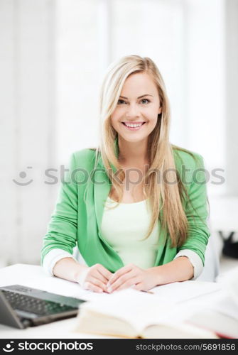 picture of smiling student girl with laptop at school