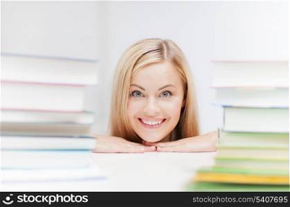 picture of smiling student with stack of books