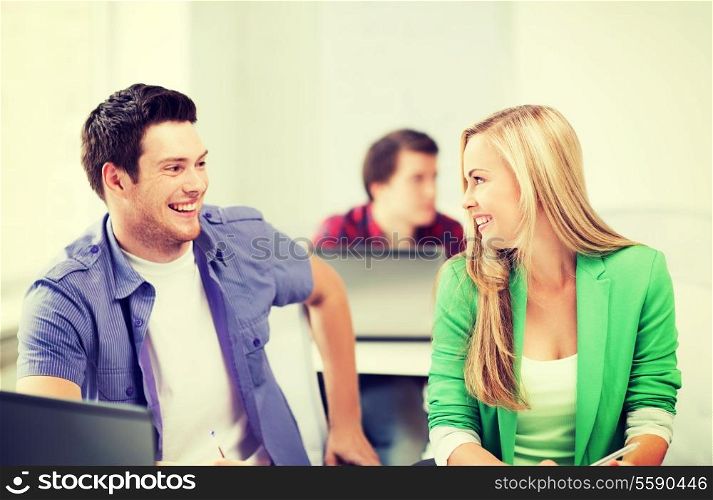 picture of smiling students looking at each other at school
