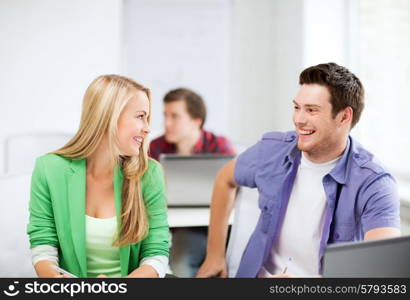 picture of smiling students looking at each other at school