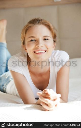 picture of smiling teenage girl on a bed