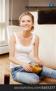 picture of smiling teenage girl with chips and coke