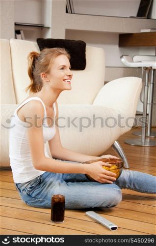 picture of smiling teenage girl with remote control