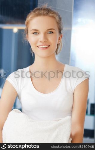picture of smiling teenage girl with towels in bathroom