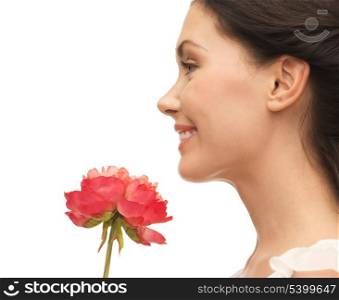 picture of smiling woman smelling flower