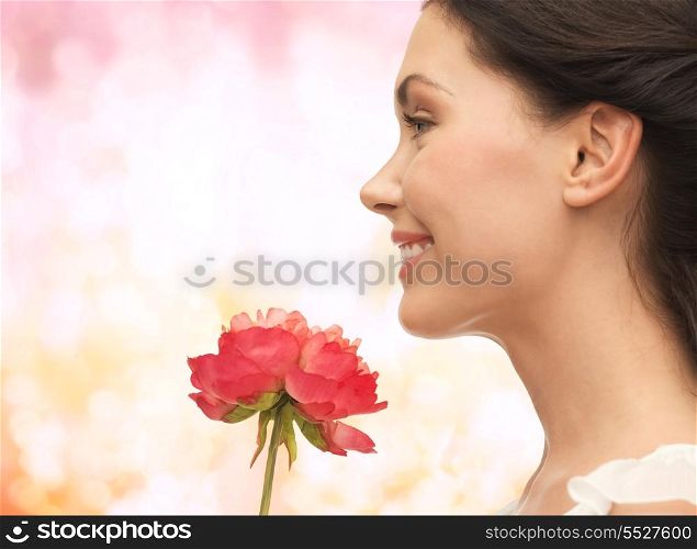 picture of smiling woman smelling flower