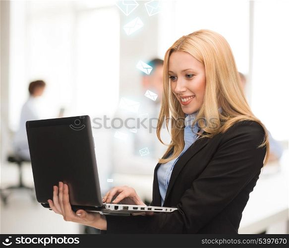 picture of smiling woman with laptop computer in office