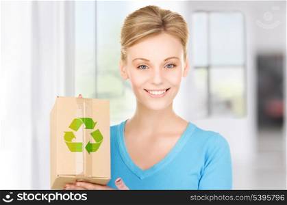 picture of smiling woman with recyclable box