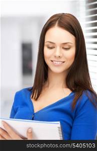 picture of smiling young businesswoman reading notes