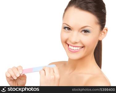 picture of smiling young woman polishing her nails