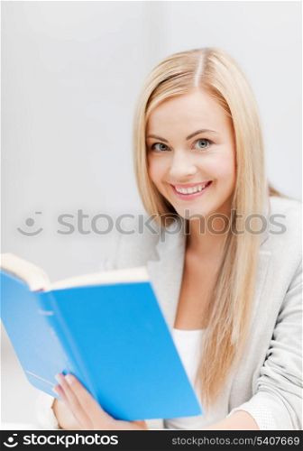 picture of smiling young woman reading book