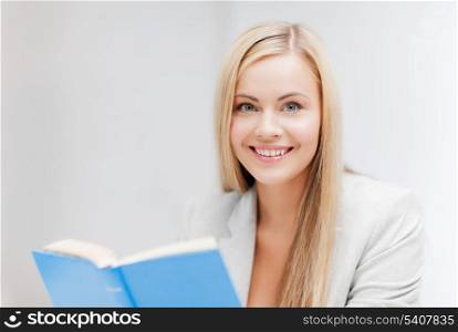 picture of smiling young woman reading book