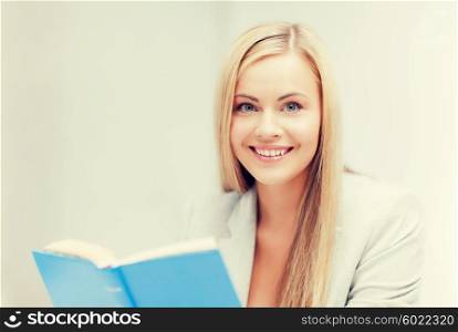 picture of smiling young woman reading book. young woman reading book