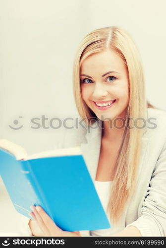 picture of smiling young woman reading book. young woman reading book