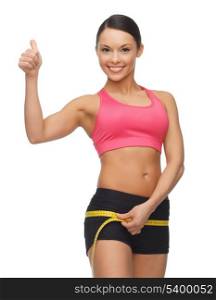 picture of sporty woman measuring her hips