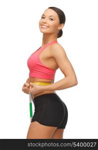 picture of sporty woman measuring her waist