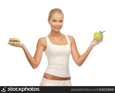 picture of sporty woman with apple and hamburger